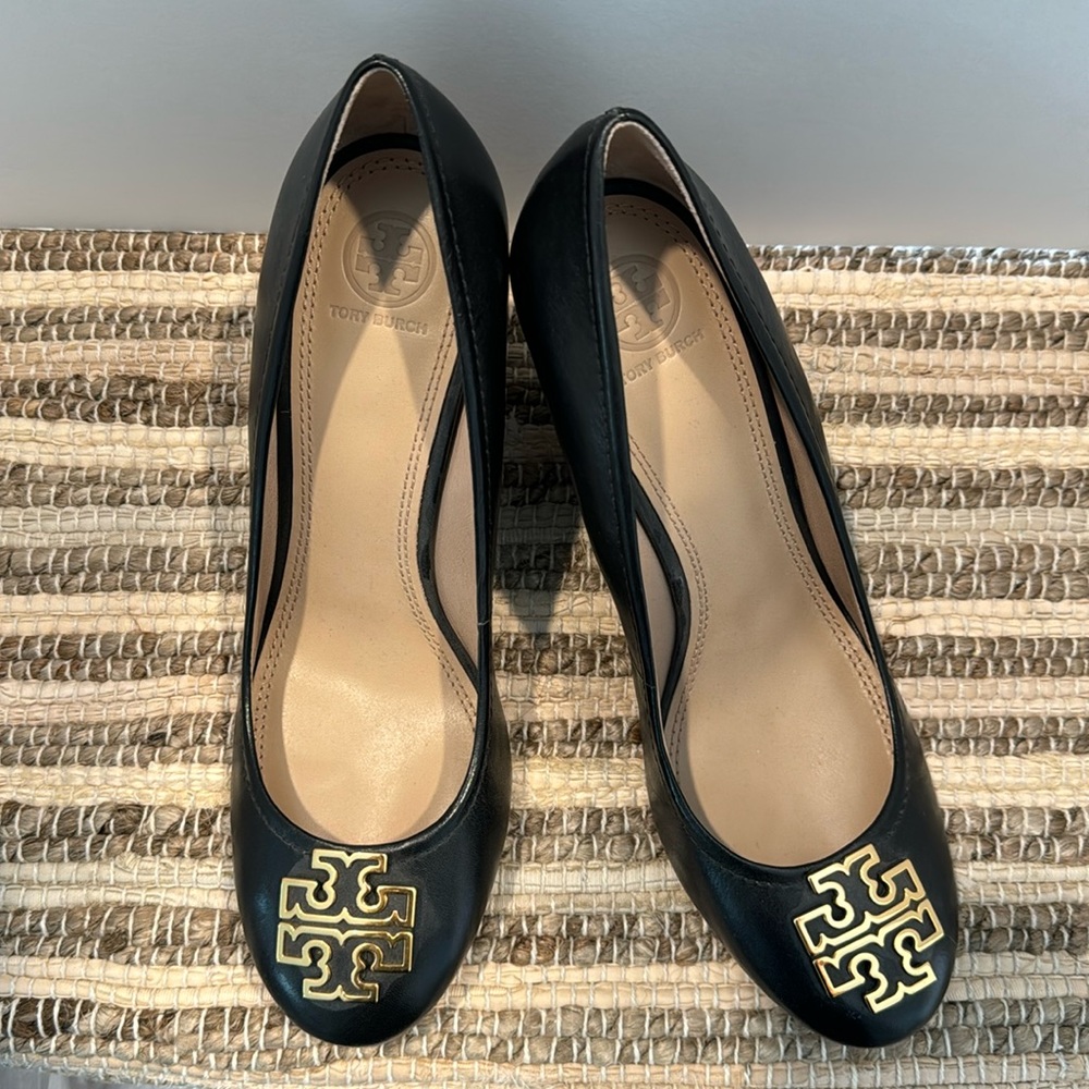 Black Tory Burch heels with Gold logo on toes.